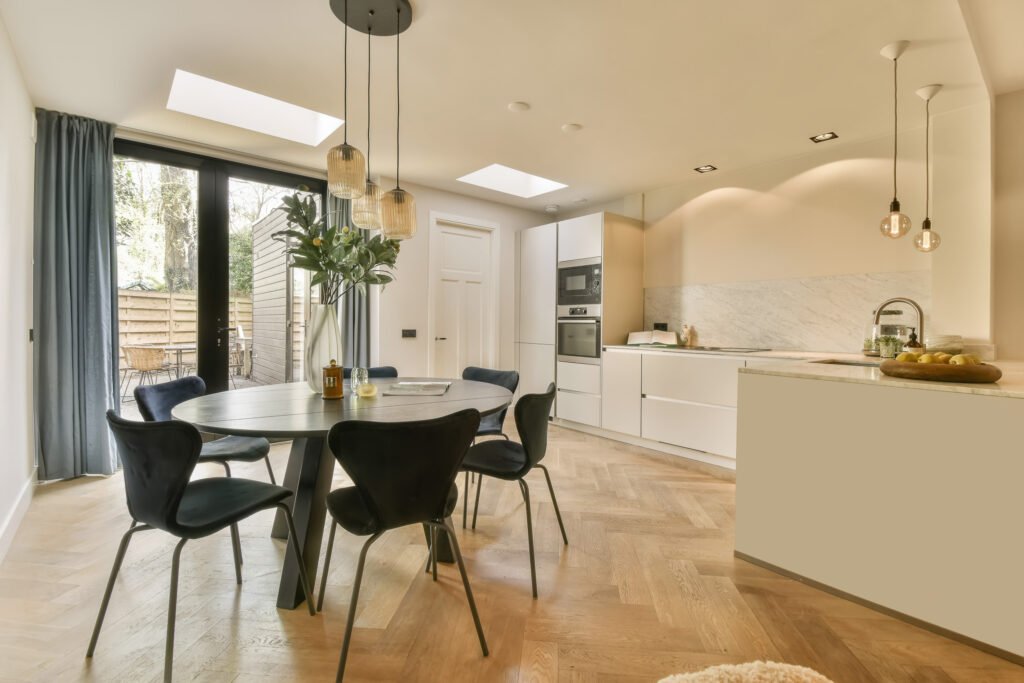 a kitchen and dining room with a table and chairs